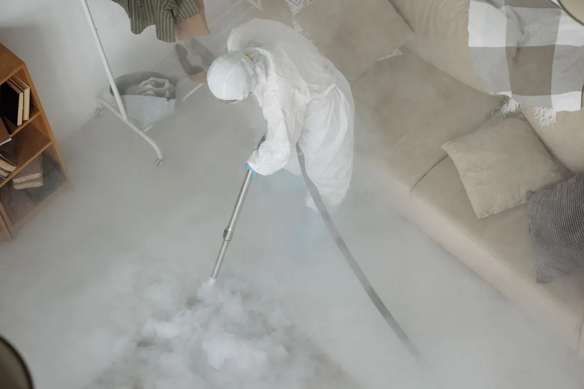 Biohazard cleanup technician in protective equipment, Lake City, FL